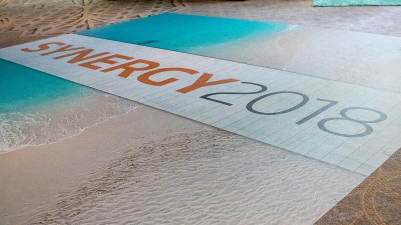 Images of the beach welcome attendees to SYNERGY for Corporations 2018