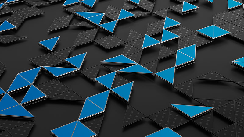 Raised blue geometric shapes on a dark gray background.