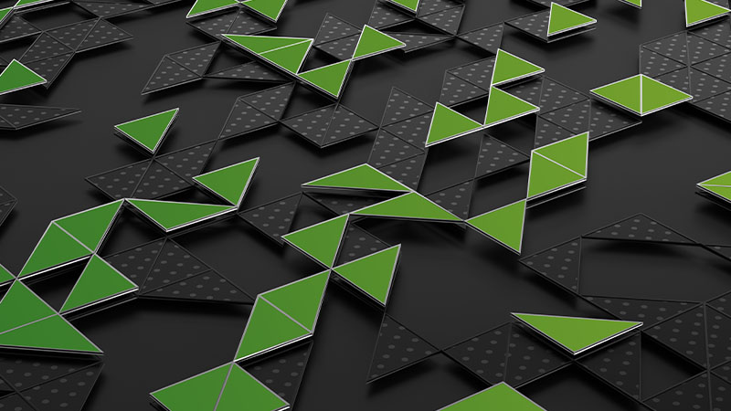 Raised green geometric shapes on a dark gray background.
