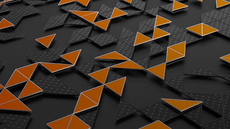 Raised orange geometric shapes on a dark gray background