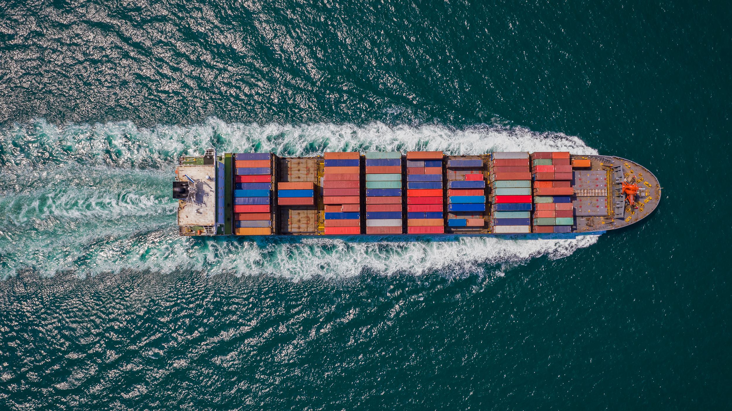 Ariel view of a cargo ship sailing in the ocean