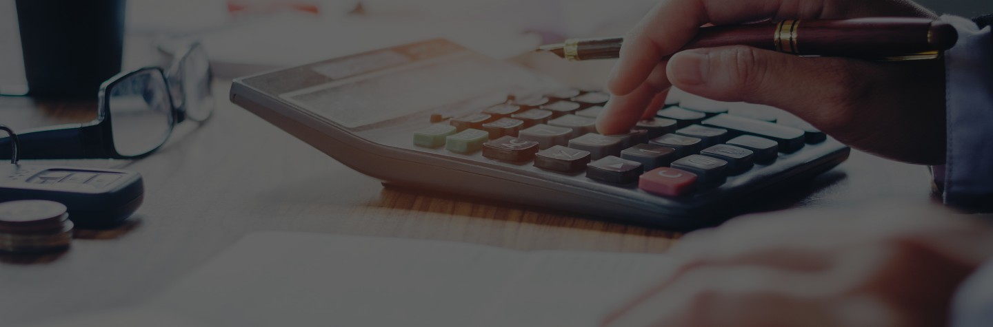 2880x1100 black overlay of a businessman's hands with calculator and cost at the office and Financial data analyzing counting on wood desk