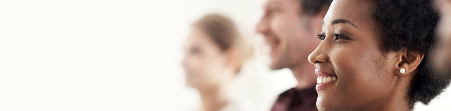 Photo of a group of colleagues standing together in a row in an office